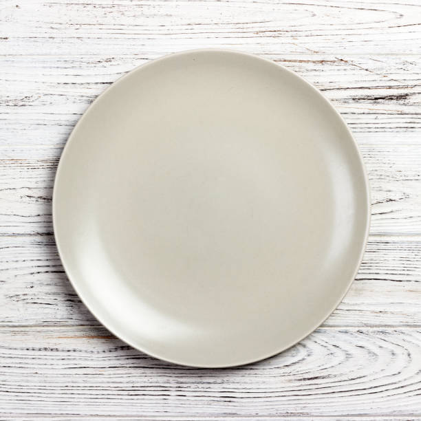 istock Top view with empty for you design. Empty white plate on wooden background 1170463176