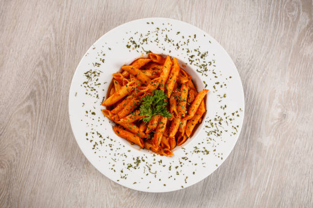 penne with tomato sauce and pork - basil bowl cooked cheese imagens e fotografias de stock