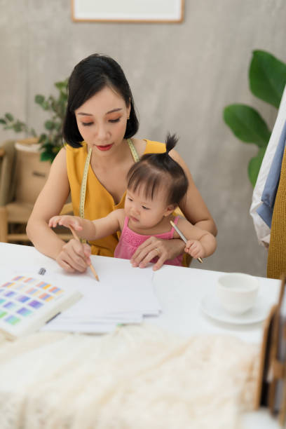 istock Young woman working with baby on her knees 1170464749