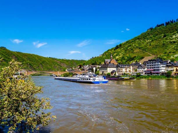 Cochem, Germany - May 05, 2013: Picturesque view of Moselle River with the Dutch motor freighter vessel Basta and the cargo ship Sennerplaat