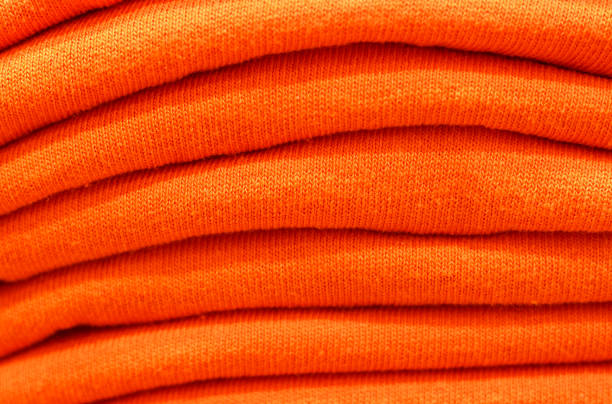 istock Stack of trend Orange Tiger woolen sweaters close-up, texture, background 1170466541