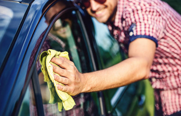 istock Man washing a car with microfiber cleaning cloth 1170467693