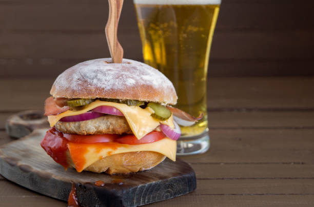 istock Home made big Burger on wooden background. 1170469215