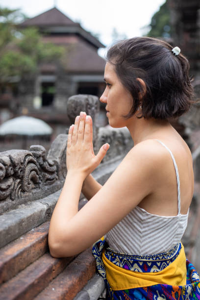 Woman praying at temple in Bali