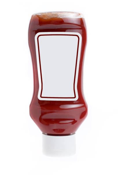 Blank label tomato ketchup glass bottle upside down on white background