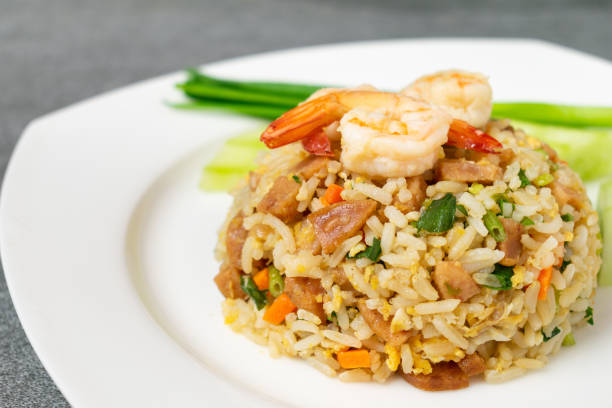 istock Fried rice with shrimp and Chinese sausage in white plate on concrete table. 1170471863