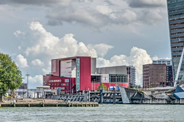 Rotterdam, The Netherlands, August 13, 2019: view across the river Nieuwe Maas towards the New Luxor Theatre with dramatic clouds behind it