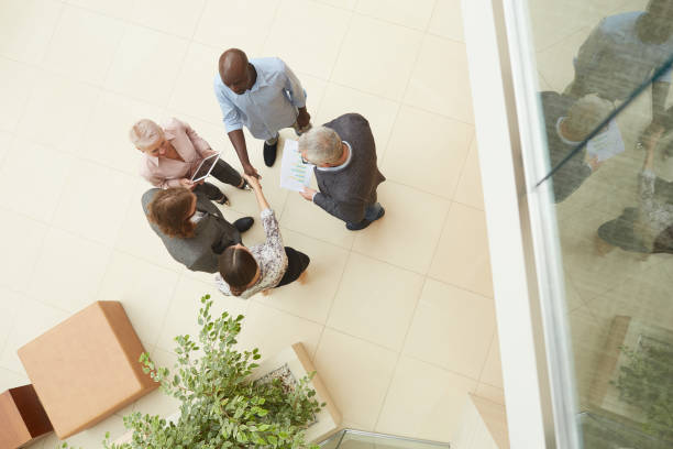 istock Group of People Meeting in Office Lobby 1170476624