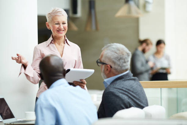 istock Senior Businesswoman Leading Training Seminar 1170476692