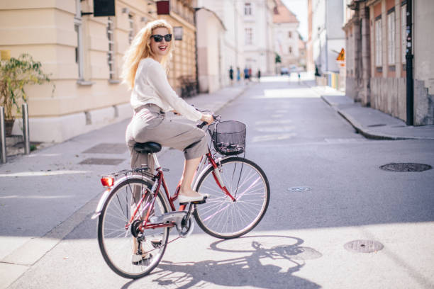 istock Blonde riding a bicycle on the street 1170477041