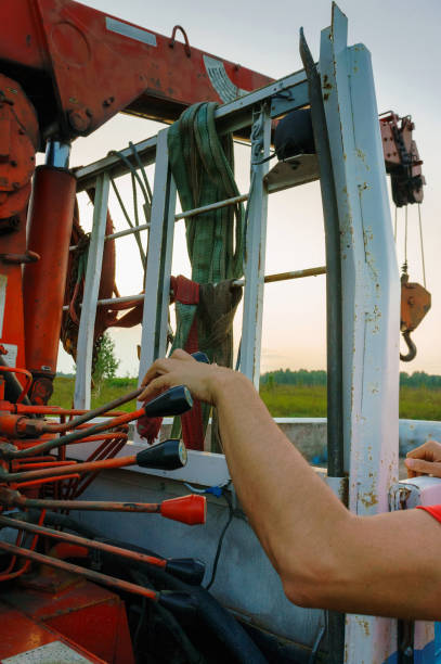 istock Hand of operator work with levers of authentic crane truck hydraulic control panel 1170477166