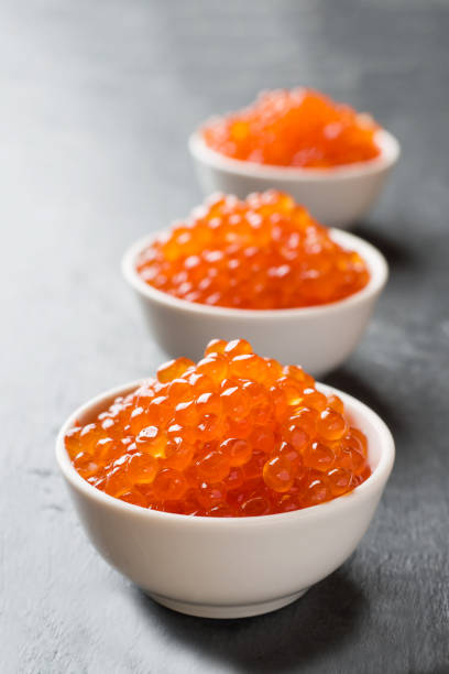 istock red salmon caviar in a plate on a dark table. 1170477304