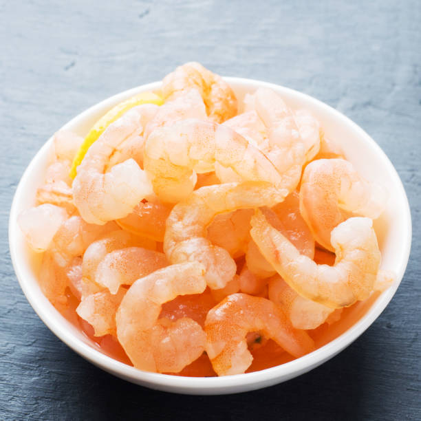 istock Shrimp with spices and lemon in a bowl close-up. 1170477317