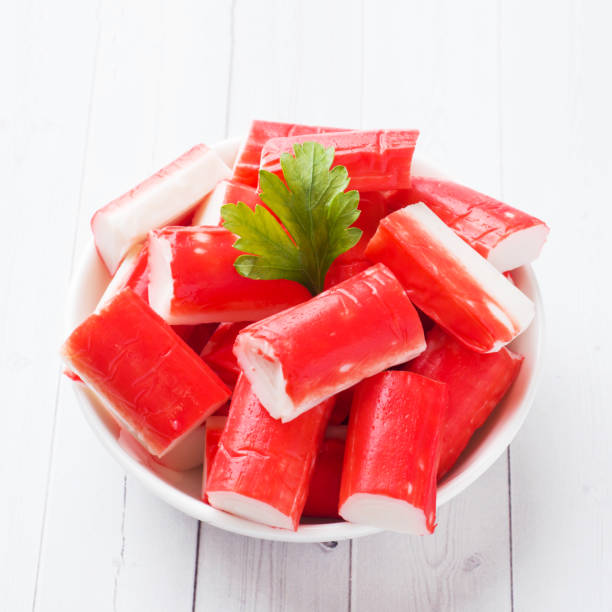 istock Salad crab sticks in a plate on a white table. 1170478279