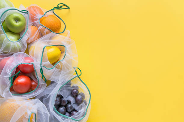 istock Fruits and vegetables in reusable eco-friendly mesh bags on bright yellow background. Zero waste shopping. Ecological concept. Stop pollution. 1170478419