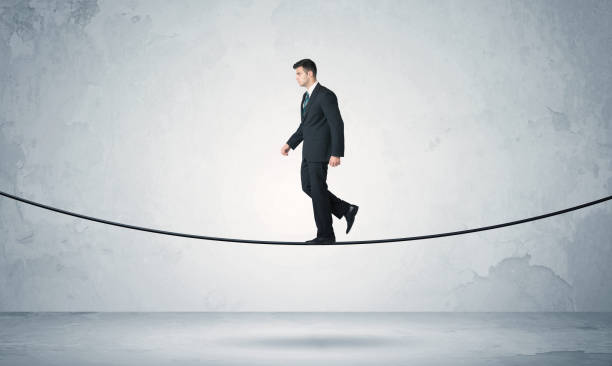 istock Sales guy balancing on tight rope 1170478658