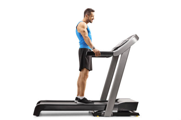 istock Young man standing on a treadmill 1170479342