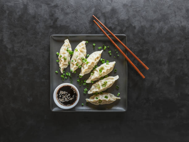 istock Dumplings with soy sauce on black square plate 1170479671