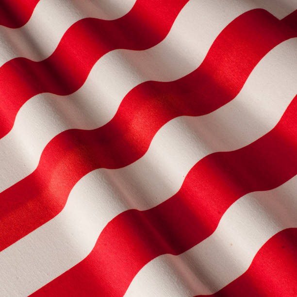 istock Fabric cotton wide red-and-white stripe. Cotton fabrics 1170480384