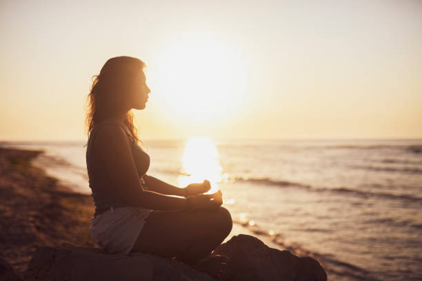 istock Woman meditation at sunrise. 1170482091