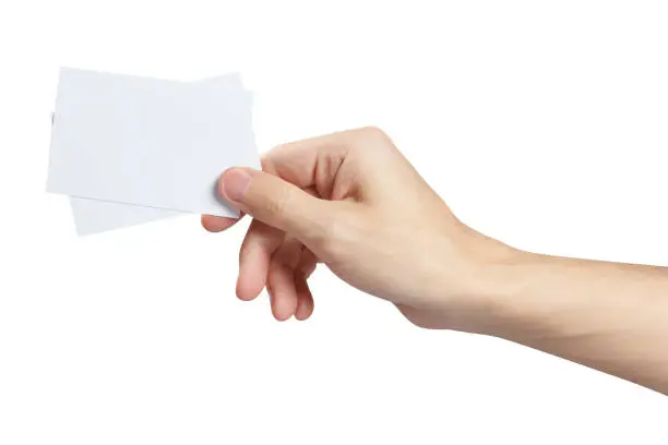 Hand holding two small pieces of paper or plastic (cards, tickets, flyers, invitations, coupons, banknotes, etc.), isolated on white background