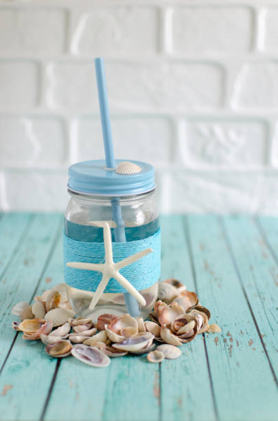 Drinking water in a jar with a straw