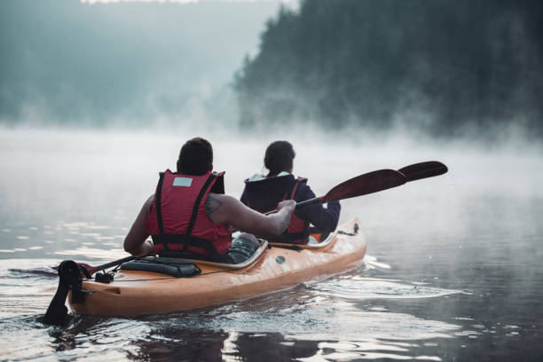 istock Young couple on kayaking adventure in mountain lake. 1170483321