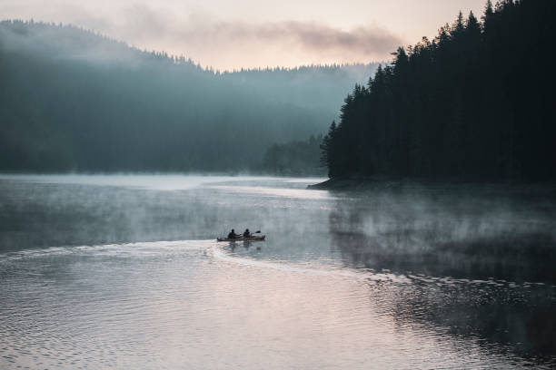 istock Young couple on kayaking adventure in mountain lake. 1170483348