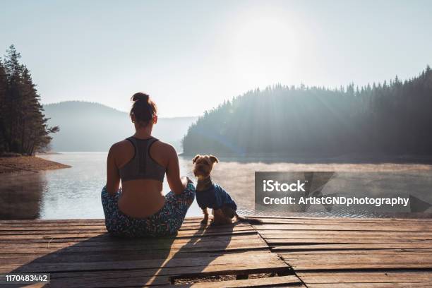 Woman Practicing Yoga At Wild Lake Stock Photo - Download Image Now - Meditating, Zen-like, Yoga