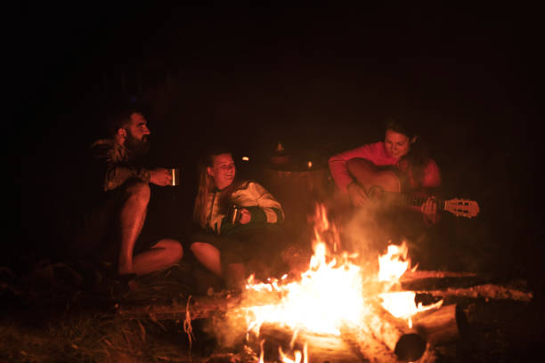 istock Group of people on camping enjoying around fire 1170483665