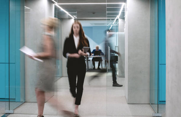 istock Business People Walking Down The Hallway 1170491900