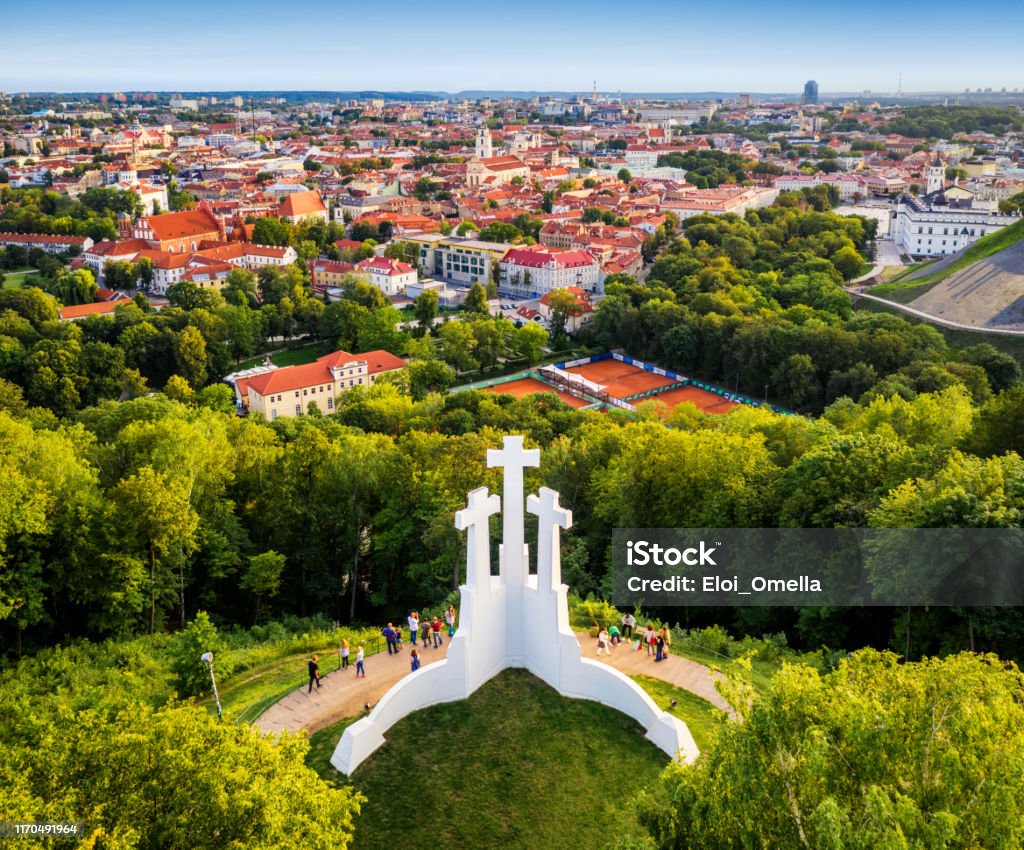 Aerial view of the Three Crosses monument overlooking Vilnius Old Town on sunset. Vilnius landscape from the Hill of Three Crosses, Lithuania Vilnius Stock Photo