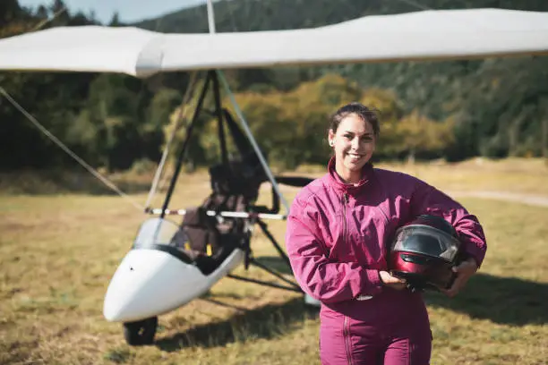 Portrait of beautiful woman hang glider pilot outdoor.