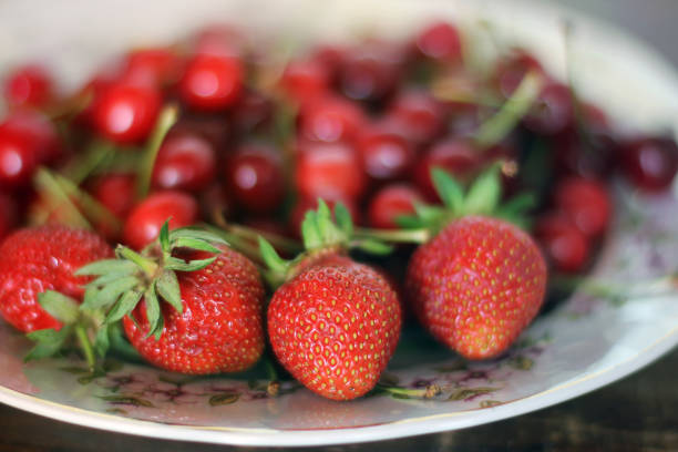 Strawberries and sweet cherries on a plate