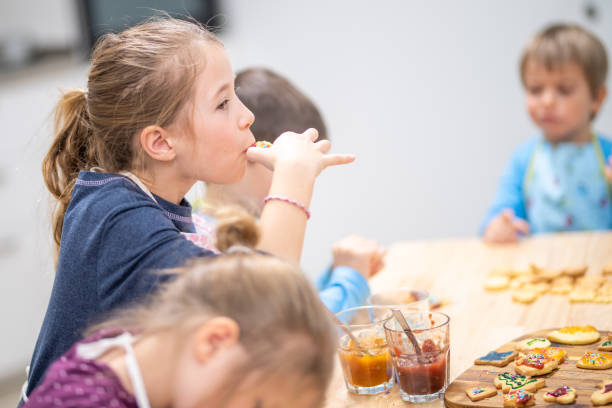 istock Girl eating cookie 1170492439