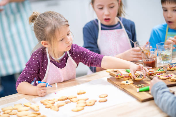 istock Children decorating cookies 1170492451