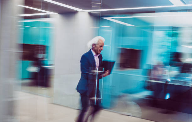 istock Businessman Holding a Laptop, Walking Down The Hallway 1170492626