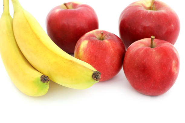istock Bananas and apples on a white background 1170493770