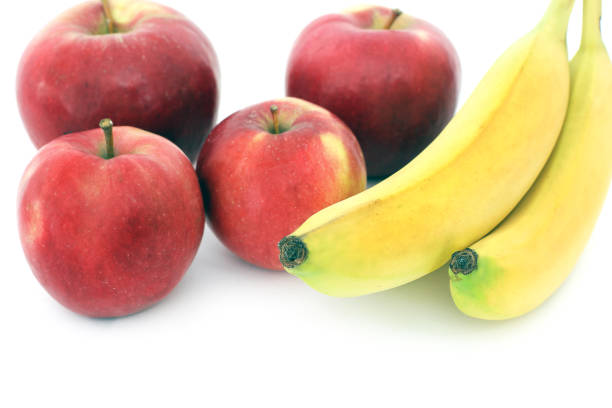 istock Bananas and apples on a white background 1170493771