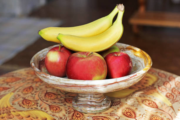 istock Apples and bananas in a marble plate 1170493784