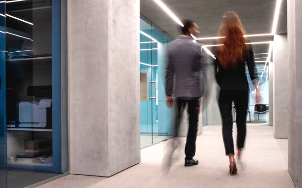 Business People Walking Down The Hallway