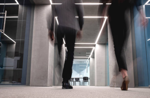 istock Business People Walking Down The Hallway 1170495549