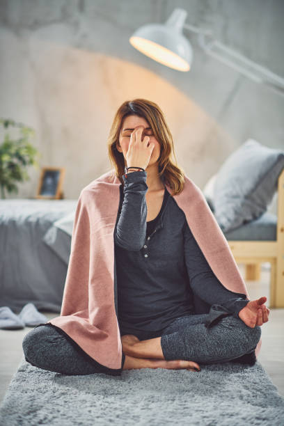 istock Woman doing breathing exercises in bedroom. 1170499426