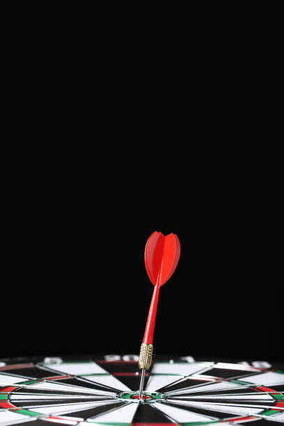 istock Dartboard with darts on black background 1170500455