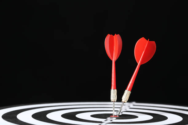 istock Dartboard with darts on black background 1170500466