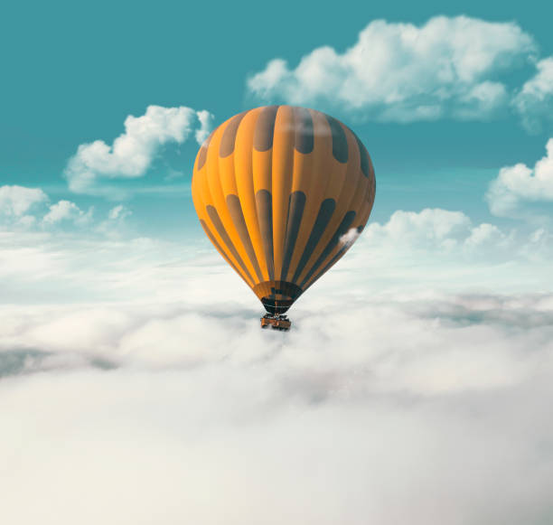 globo de aire caliente amarillo volando por encima de las nubes - despegar actividad fotografías e imágenes de stock