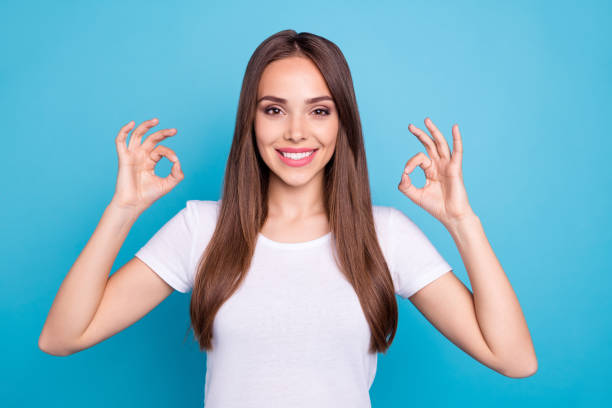 Portrait of her she nice-looking attractive optimistic positive cheerful cheery content straight-haired lady showing two ok-sign isolated over bright vivid shine blue green teal turquoise background