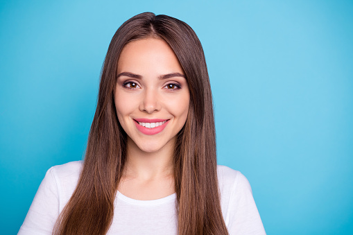 Close-up portrait of her, she nice-looking attractive lovely lovable winsome pretty cheerful cheery straight-haired girl isolated over bright vivid shine blue background