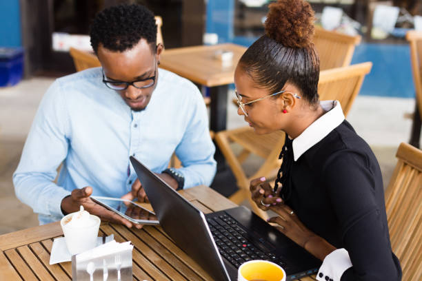 istock Black  African American coworkers doing digital teamwork arround a coffee cup 1170502895