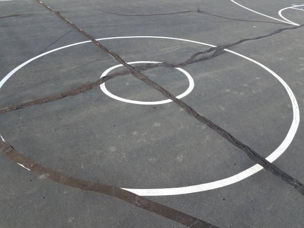 istock black asphalt with white lines and black caulk 1170503403